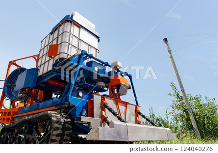 Autonomous robot sprayer works in a fruit garden. Smart farming concept. 124040276