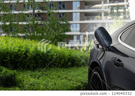 Close up of electric car inlet with a connected charging cable Close up of electric car inlet with a connected charging cable 124040332