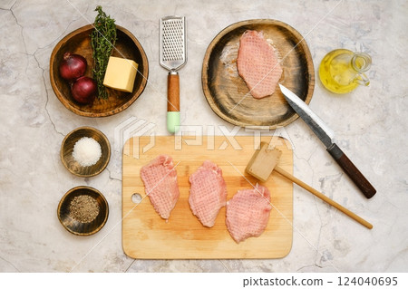Preparing pork chops with fresh herbs and seasonings for a delicious meal 124040695