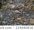 Rustic stone wall texture.  Irregularly shaped stones in shades of gray and brown, set in mortar. Perfect for backgrounds, textures, or design projects needing a vintage, aged aesthetic. 124040816