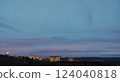 Serene twilight scene lowlight cityscape with residential buildings nestled against a hill, under a soft pastel sky. Perfect for tranquil, evening, or urban landscape themes. 124040818