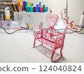 Adorable pink 3Dprinted bench with heart detail, perfect for Valentines Day, romance, or craft project visuals.  Closeup shot showing intricate design. Ideal for blogs, websites, and social media. 124040824