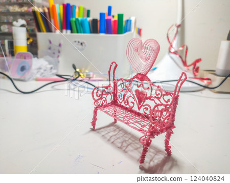 Adorable pink 3Dprinted bench with heart detail, perfect for Valentines Day, romance, or craft project visuals.  Closeup shot showing intricate design. Ideal for blogs, websites, and social media. 124040824
