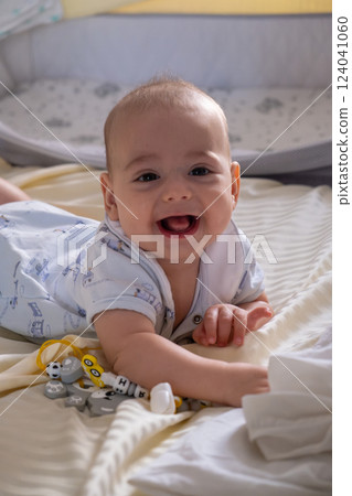 Happy Baby Playing with Toys on a Blanket 124041060
