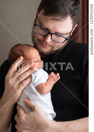 Man Holding Newborn Baby in Tender Moment 124041208