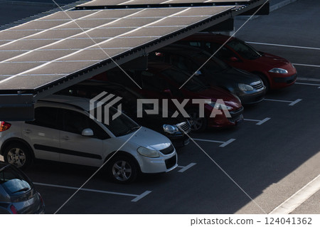 Parking space with solar panels on a roof. Solar canopy 124041362
