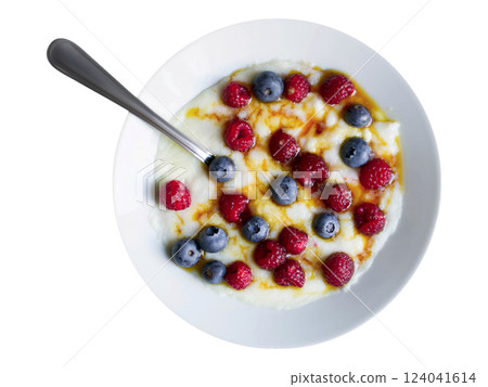 Creamy porridge topped with fresh raspberries and blueberries, drizzled with honey. Creamy porridge topped with fresh raspberries and blueberries, drizzled with honey. 124041614