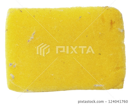 A wellused yellow cleaning sponge, slightly soiled, sits on a stark white background. 124041760