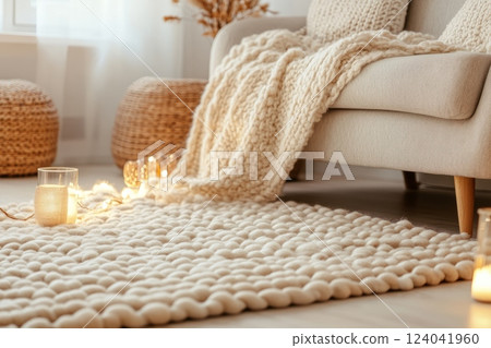 Cozy scandinavian living room with soft woolen rug and knitted pouf Cozy scandinavian living room with soft woolen rug and knitted pouf 124041960