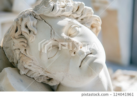 Dramatic close up of damaged roman bust showing the passage of time 124041961
