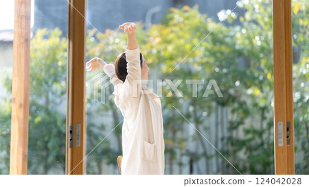 Middle-aged woman taking a deep breath 124042028