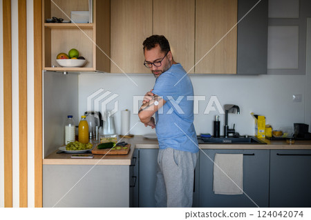 Diabetic man with CGM sensor making healthy breakfast. Diabetic man with CGM sensor making healthy breakfast. 124042074