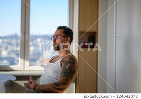 Portrait of handsome man with CGM sensor. 124042078