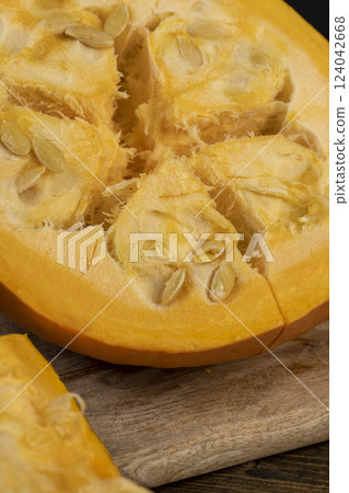 ripe orange pumpkin with seeds cut into pieces ripe orange pumpkin with seeds cut into pieces 124042668
