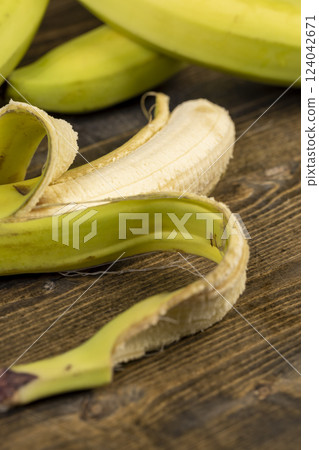 a ripe banana with a yellow-green peel is on the table 124042671