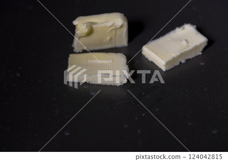 cooking using butter that melts in a black pan cooking using butter that melts in a black pan 124042815