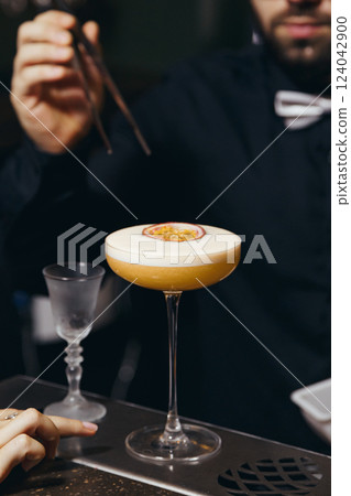 sweet and sour refreshing cocktail decorated with passion fruit on the bar counter sweet and sour refreshing cocktail decorated with passion fruit on the bar counter 124042900