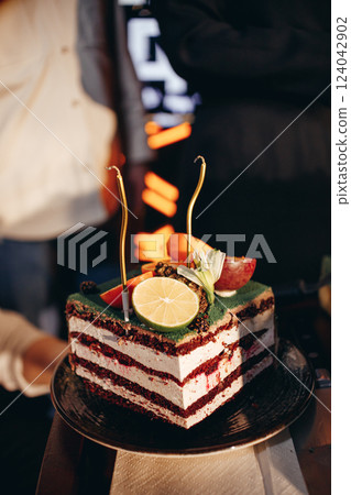 Waiter in white shirt bringing the ordered dessert and cup of coffee in a cafe 124042902