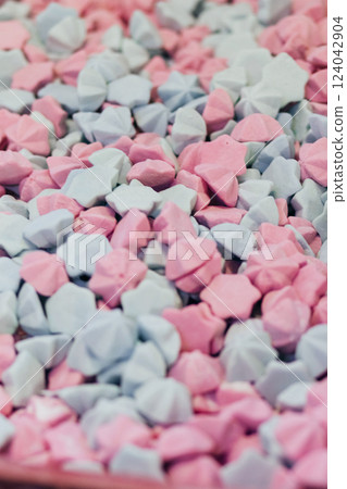 Industrial production of sweeties. Light pink and mint marshmallows background, sugar confetti Industrial production of sweeties. Light pink and mint marshmallows background, sugar confetti 124042904
