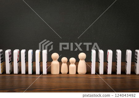 Dominoes and wooden figures on the table. Abstract business and skills concept 124043492