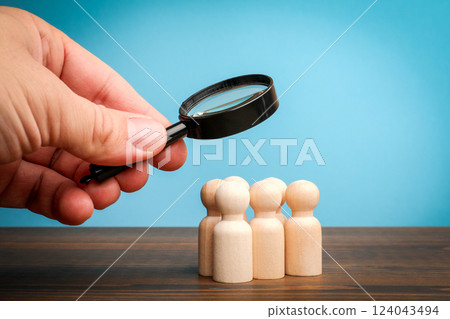 Recruitment and search concept. Miniature figures on a wooden table Recruitment and search concept. Miniature figures on a wooden table 124043494