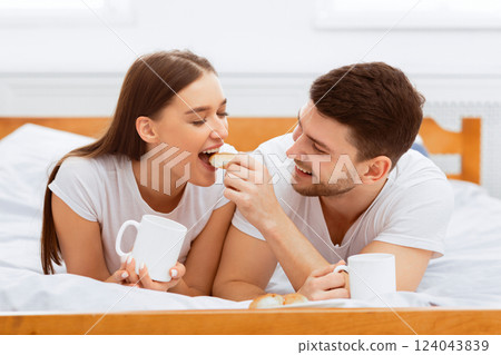 Breakfast In Bed. Loving Couple Drinking Coffee And Feeding Each Other Having Morning Date In Bedroom. 124043839