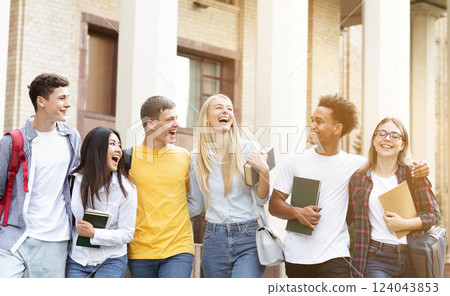 Happy students walking together in campus, having break in university Happy students walking together in campus, having break in university 124043853