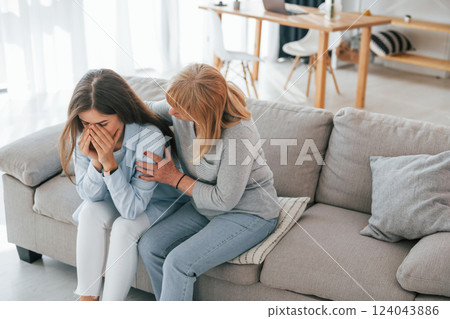 Woman supports her daughter. Mother and woman is together at home 124043886