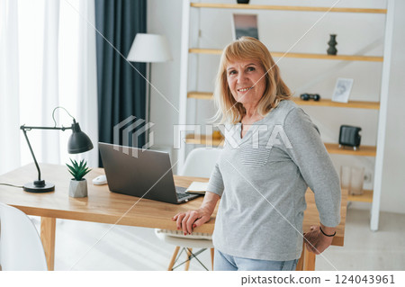 Senior woman with red hair is at home alone 124043961