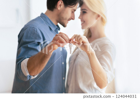 House Owners. Loving Couple Holding Keys Hugging In New Flat. Shallow Depth, Selective Focus House Owners. Loving Couple Holding Keys Hugging In New Flat. Shallow Depth, Selective Focus 124044031