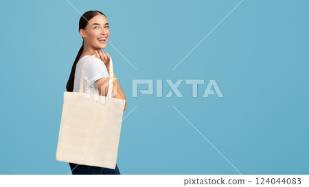 Woman With White Tote Shopping Bag Smiling At Camera Posing Over Turquoise Studio Background. Eco-Friendly Lifestyle. 124044083