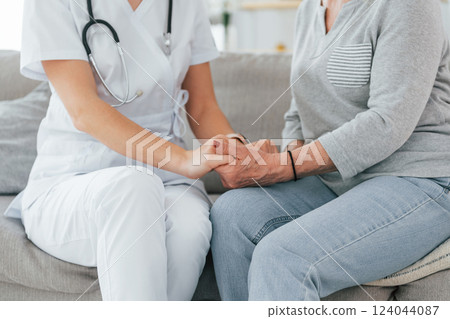 Conception of trust and help. Senior woman have consultation by young female doctor indoors 124044087