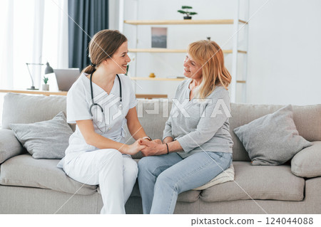 Senior woman have consultation by young female doctor indoors 124044088