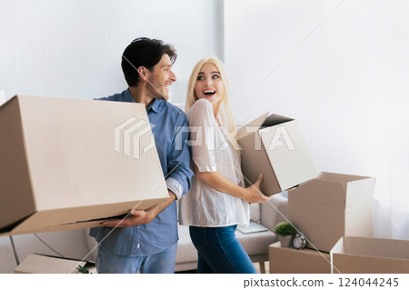 Excited Spouses Carrying Moving Boxes Smiling Looking At Each Other Leaving Old Flat. Free Space Excited Spouses Carrying Moving Boxes Smiling Looking At Each Other Leaving Old Flat. Free Space 124044245