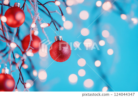 Festive red baubles and glowing fairy lights on blue background for holiday celebration concept, AI Generative Festive red baubles and glowing fairy lights on blue background for holiday celebration concept, AI Generative 124044347