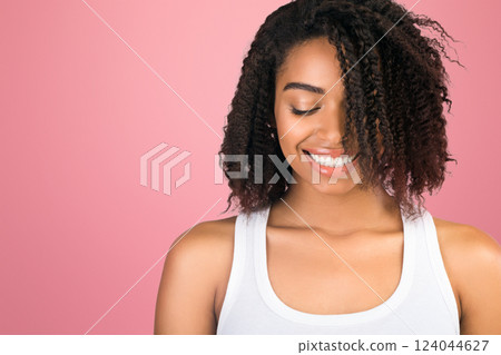 Shy Girl. Portrait of beautiful african american woman looking down and smiling over white background 124044627