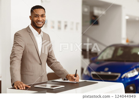 Car Sales Manager Working Selling Automobiles Standing At Desk In Luxury Dealership Office. Selective Focus, Copy Space 124044949