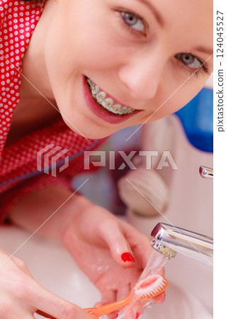 Woman brushing cleaning teeth in bathroom 124045527