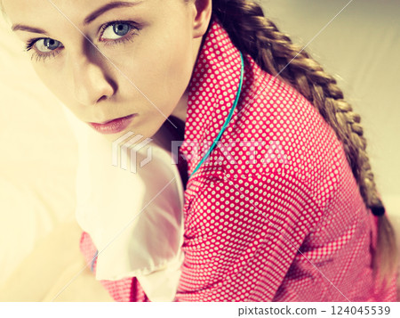 Sad young teenager woman sitting on bed 124045539