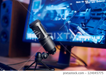 Close up view of microphone. PC at home with shooter game launched on. FPS experience virtual reality Close up view of microphone. PC at home with shooter game launched on. FPS experience virtual reality 124045775
