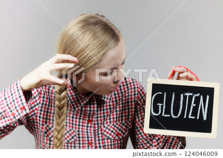 Angry woman holding board with gluten sign 124046009