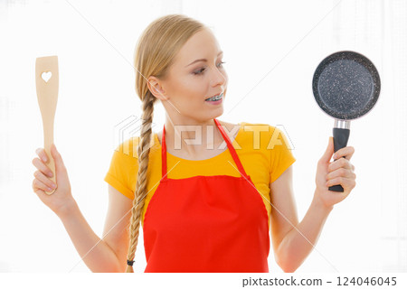 Woman holding cooking pan and spatula 124046045