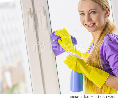 Girl cleaning window at home 124046060