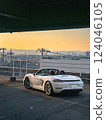 Sunset sky and Porsche 718 Boxster open car convertible 124046105