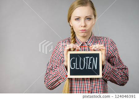 Woman holding board with gluten sign Woman holding board with gluten sign 124046391