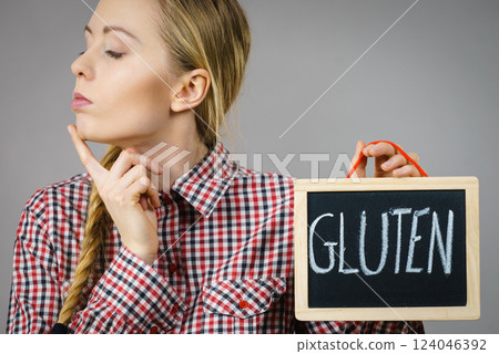 Woman holding board with gluten sign Woman holding board with gluten sign 124046392
