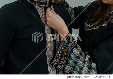 Close-up Detail of Female Hands Adjusting Traditional Colorful Embroidered Ethnic Clothing Sleeve Collar 124046681