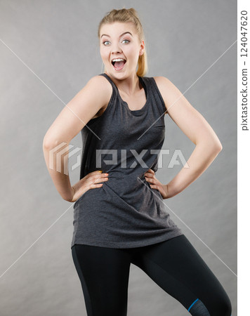 Happy woman wearing black tank top Happy woman wearing black tank top 124047620