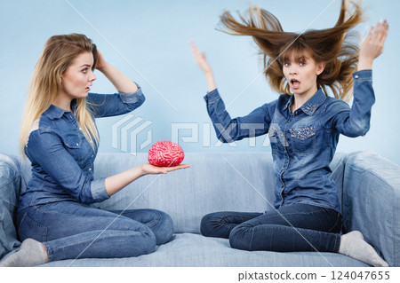 Two women friends thinking Two women friends thinking 124047655