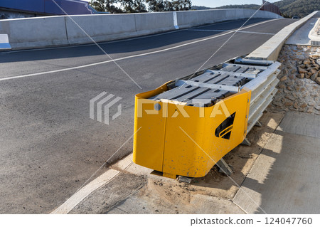 Crash cushion barrier at end of road barricade for safety. They absorb impact in the event of automobile crash 124047760